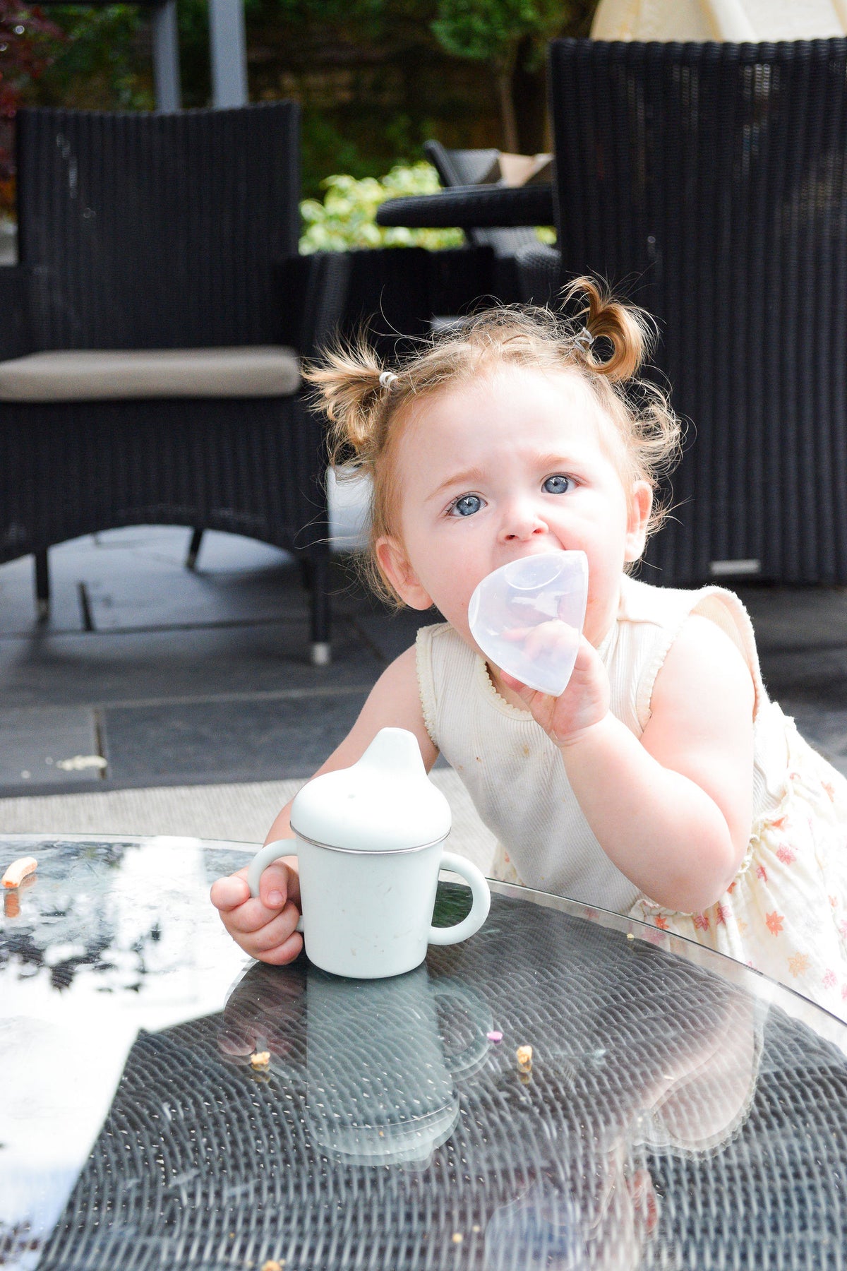 Toddler with her Bubba Fresh sippy cup at the garden table